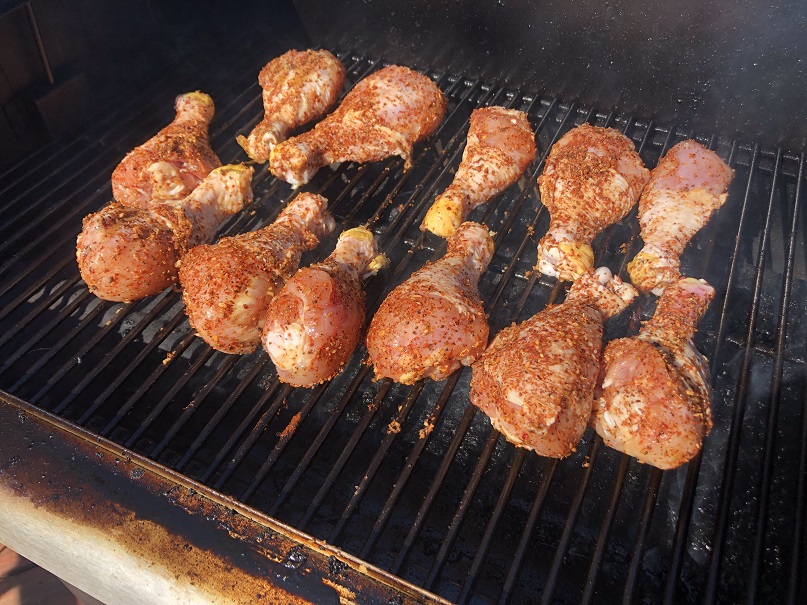Seasoned chicken legs on pellet grill